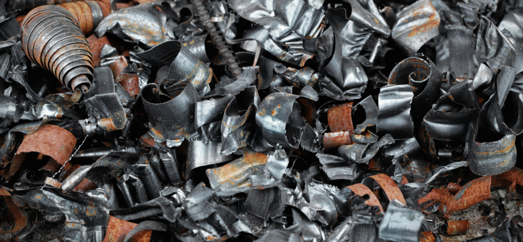 Close-up of curled and rusty steel shavings collected for scrap recycling.
